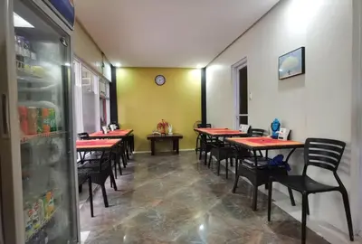 a row of tables and chairs in a restaurant at Sunny Day Residences Cainta in Cainta