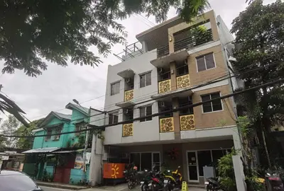 a building with motorcycles parked in front of it at Sunny Day Residences Cainta in Cainta