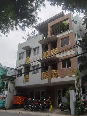 a building with motorcycles parked in front of it at Sunny Day Residences Cainta in Cainta