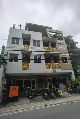 a building with motorcycles parked in front of it at Sunny Day Residences Cainta in Cainta