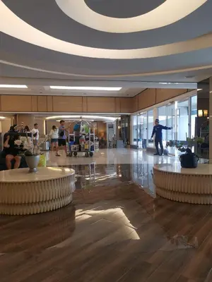 a lobby of a building with people in it at Shell Family Suites Ocean & MOA view in Manila