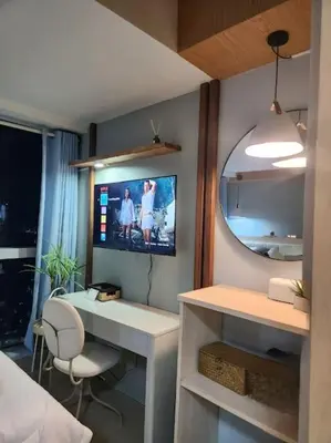 a room with a desk and a tv on the wall at LuxeStaysMnl Coastal Chic Netflx 380MBPS Pool BGC in Manila