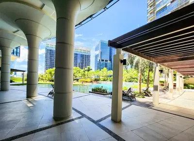 a view of a building with columns and a pool at LuxeStaysMnl Coastal Chic Netflx 380MBPS Pool BGC in Manila