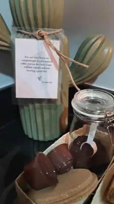 a jar of chocolates sitting next to a jar of candy at The New Villa at Sea Residences in Manila