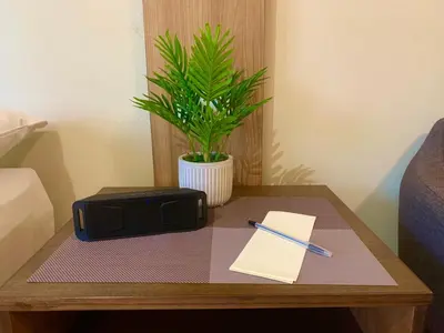 a table with a pencil and a notebook and a pen at Shell Residences Mall of Asia Pasay in Manila