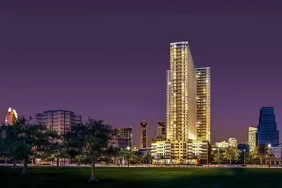 a city skyline at night with tall buildings at Breeze Residences 26th floor in Manila