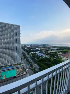 a view of a city from a balcony of a building at Breeze Residences 26th floor in Manila