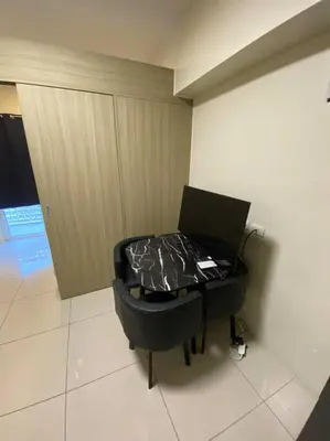 a room with a black table with plastic on it at Breeze Residences 26th floor in Manila