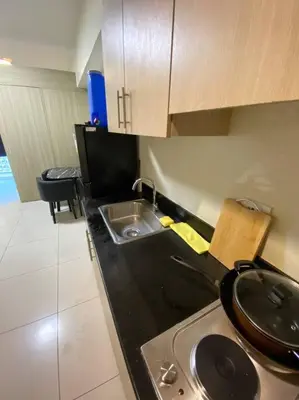 a kitchen with a sink and a counter top at Breeze Residences 26th floor in Manila
