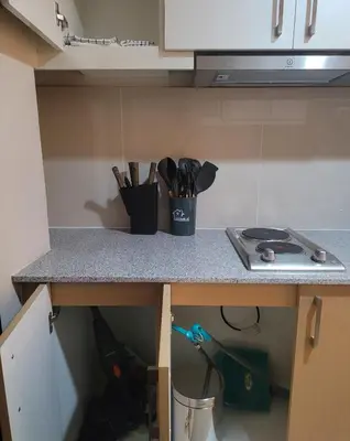 a kitchen counter with a cup of utensils on it at Uptown Parksuites Tower 1 at BGC - Staycations Up Above 12 in Manila