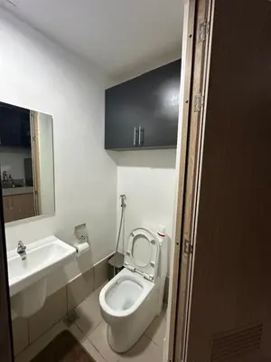 a bathroom with a toilet and a sink at M&Ms Place in Dasmariñas