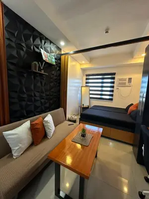 a living room with a couch and a table at M&Ms Place in Dasmariñas