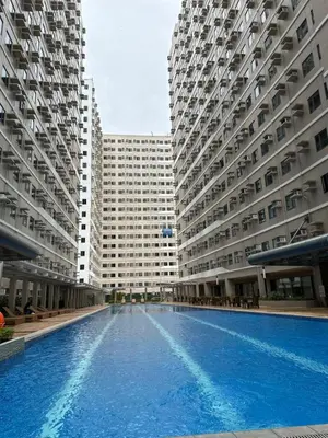 a swimming pool in the middle of two large buildings at M&Ms Place in Dasmariñas