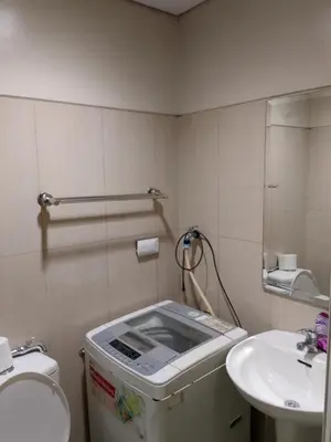 a small bathroom with a toilet and a sink at Shell Residences MOA 3 in Manila