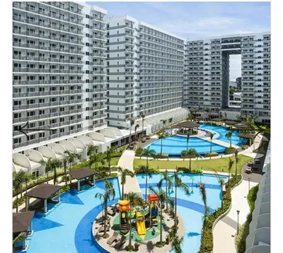an aerial view of a resort with two pools at Shell Residences MOA 3 in Manila
