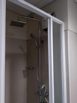 a shower with a shower head in a bathroom at Shell Residences MOA 3 in Manila