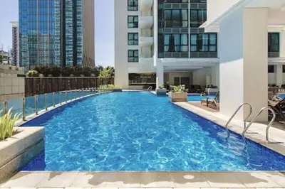 a swimming pool in the middle of a building at LUXESTAYSMNL ELEGANT FAMILY 2BR SUITE POOLGYM 400MBPS WIFI NETFLX AMAZING CITY VIEW in Manila