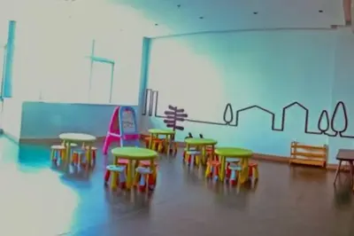 a classroom with colorful tables and chairs in a room at LUXESTAYSMNL ELEGANT FAMILY 2BR SUITE POOLGYM 400MBPS WIFI NETFLX AMAZING CITY VIEW in Manila