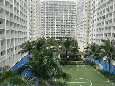 an aerial view of a tennis court in front of tall buildings at SHORE RESIDENCE D14 shortwalk Mall of asia near airport in Manila