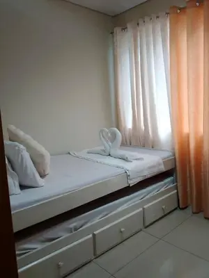 a bed with a pair of swans sitting on it at Shell Residences 2BR & 2CR 101D in Manila