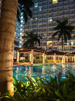 a swimming pool in front of a large building at Shell Residences 2BR & 2CR 101D in Manila