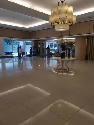 a lobby with a table in the middle of a building at Shell Residences 2BR & 2CR 101D in Manila