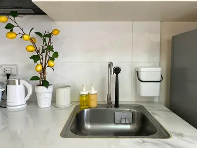 a kitchen counter with a sink with oranges on it at Avida Towers New Manila near Crame, Cubao and Greenhills in Manila