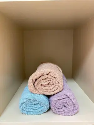 a pile of towels sitting on a shelf at Avida Towers New Manila near Crame, Cubao and Greenhills in Manila