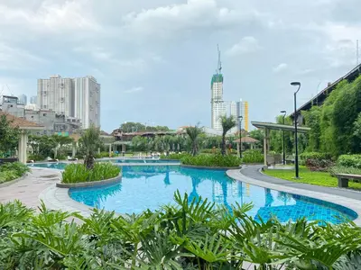 a swimming pool in a city with tall buildings at Cozy 1 BR Scandinavian/Tropical Condo with Balcony & Parking in Manila