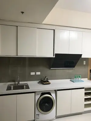 a kitchen with a sink and a washing machine at Beachfront U.S. Embassy Family Retreat. in Manila