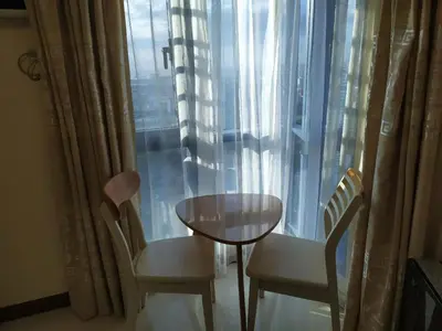 a table and two chairs in front of a window at Beachfront U.S. Embassy Family Retreat. in Manila