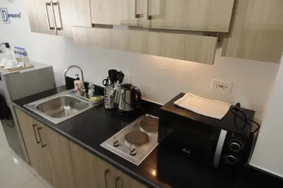 a small kitchen with a sink and a microwave at NAIA Airport 956 DYNASTEL SHORE Staycation in Manila