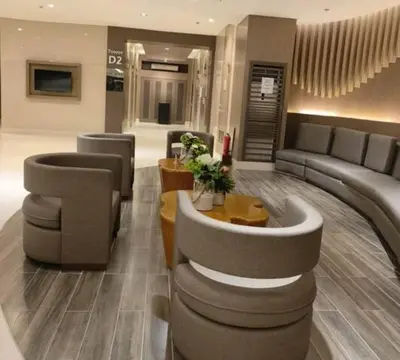 a lobby with a couch and chairs and a table at NAIA Airport 956 DYNASTEL SHORE Staycation in Manila