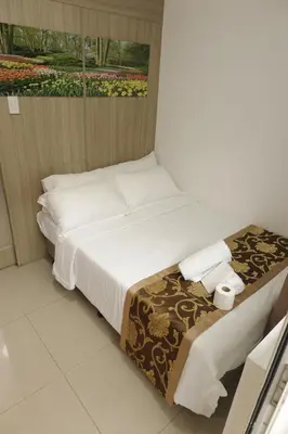 a hotel room with a bed and a window at MOA Arena 1155 CONDOTEL DYNASTEL SHORE in Manila