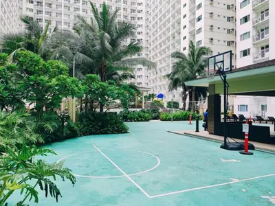 a basketball court in the middle of a street with buildings at MOA Arena 1155 CONDOTEL DYNASTEL SHORE in Manila