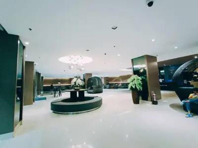a lobby with a table in the middle of a building at MOA Arena 1155 CONDOTEL DYNASTEL SHORE in Manila