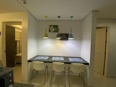 a dining room with a table and chairs at 60 percent Off Deluxe Ocean View Rooms FREE Pool and FREE Sauna Access Included Perfect Location Near US Embassy, NAIA, Makati, BGC, Mall of Asia, and Chinatown Dont Miss Out Book Now and Save Updated Price 2025 in Manila
