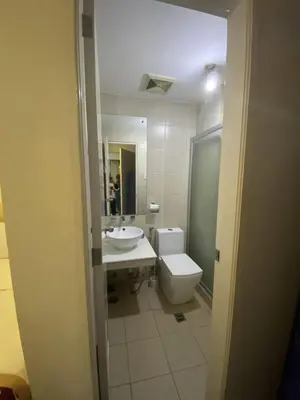a bathroom with a sink and a toilet and a mirror at 60 percent Off Deluxe Ocean View Rooms FREE Pool and FREE Sauna Access Included Perfect Location Near US Embassy, NAIA, Makati, BGC, Mall of Asia, and Chinatown Dont Miss Out Book Now and Save Updated Price 2025 in Manila