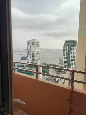 a balcony with a view of a city with buildings at 60 percent Off Deluxe Ocean View Rooms FREE Pool and FREE Sauna Access Included Perfect Location Near US Embassy, NAIA, Makati, BGC, Mall of Asia, and Chinatown Dont Miss Out Book Now and Save Updated Price 2025 in Manila