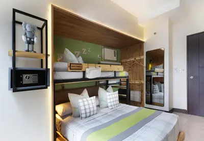 a bedroom with a bunk bed with white and green at Spacious Family Sleeper BGC & 84inch Cinema in Manila