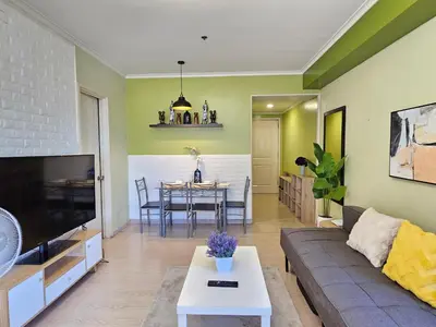 a living room with a couch and a table at South of Market near High Street BGC Classy & Stylish Studio, central location with city view in Manila