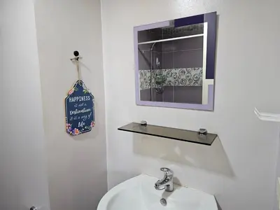 a white bathroom with a sink and a mirror at South of Market near High Street BGC Classy & Stylish Studio, central location with city view in Manila