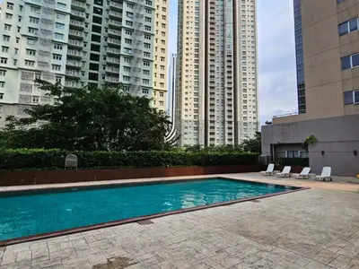 a swimming pool in front of some tall buildings at South of Market near High Street BGC Classy & Stylish Studio, central location with city view in Manila