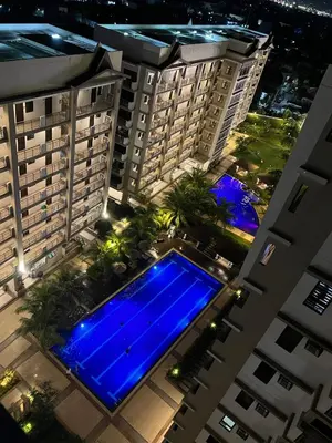 an overhead view of a swimming pool in the middle of two buildings at Brand new condo for travelers in Paranaque near airport in Manila