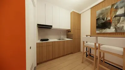 a small kitchen with white cabinets and a counter at Near Manila Airport, MAILZ HOMEZ COZY Hotel Style Studio Condo, Avida Towers Sucat, Full Kitchen, Swimming Pool, WIFI, 5G in Manila