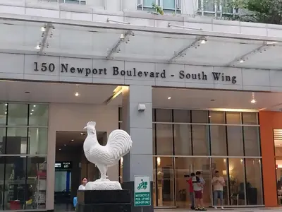 a statue of a rooster in front of a building at Alps at 150 Newport Blvd Condominum near T3 in Manila