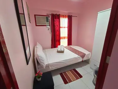a small room with a bed and a window at Near Manila Airport, COZY 1 Bedroom Condo, Full Kitchen, Swimming Pool, WIFI, 10K in Manila