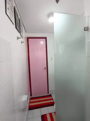 a bathroom with a red door and a red and white floor at Near Manila Airport, COZY 1 Bedroom Condo, Full Kitchen, Swimming Pool, WIFI, 10K in Manila