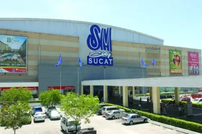 a swm suvent store with cars parked in a parking lot at Near Manila Airport, COZY 1 Bedroom Condo, Full Kitchen, Swimming Pool, WIFI, 10K in Manila