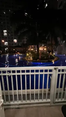 a white fence with a pool of water behind it at Direct Pool Access Shore Residences MOA Pasay Near Airport in Manila